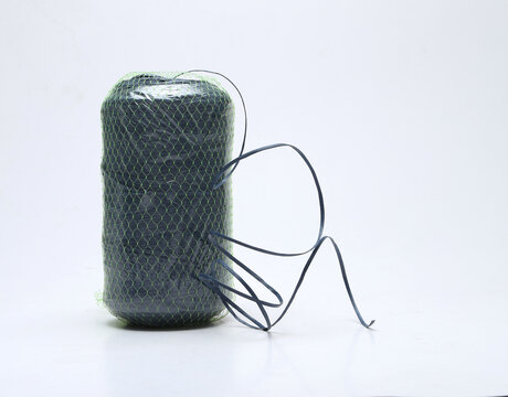 green plastic rope roll isolated on white background