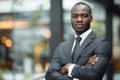 © Emanuel - Attractive black business executive with arms crossed, exuding confidence and professionalism