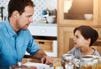 Canvas Print - Talking, boy and dad with breakfast in kitchen for communication, nutrition and development. Hungry, man and kid chat in home with drink for wellness, love and health food or conversation and bonding