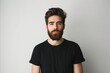 © VISUAL BACKGROUND - A man with a beard and a black t - shirt.