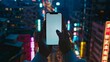 © Mrzproducer - woman holding a smartphone in her hands against the background of a night city.