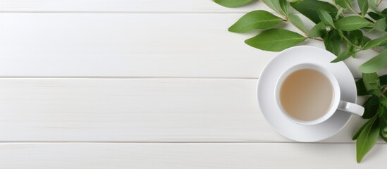 Aufkleber - Copy space image of a white wooden table adorned with green leaves and a cup of sage tea perfect for adding text