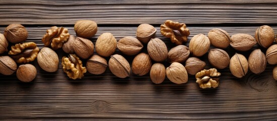 Aufkleber - A close up copy space image of walnuts scattered on a wooden background
