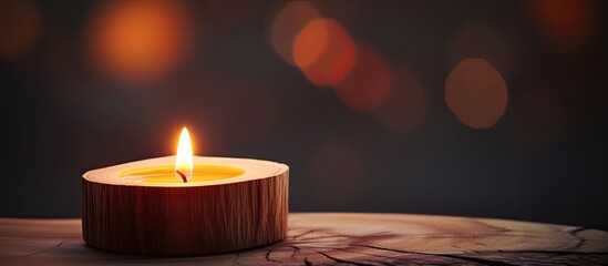 Aufkleber - A wooden top with a lit candle on it creating a warm and cozy ambiance A copy space image to be used in various settings