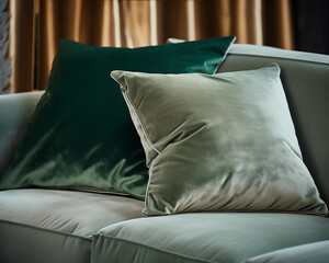 Elegant green and gray velvet pillows on a modern sofa