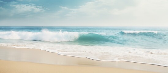 Leinwandbilder - A tropical beach with blurred waves and sand in the foreground Offers plenty of copy space for your image
