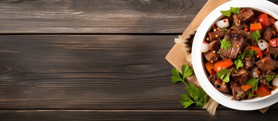 Poster - Top view copy space image of a beef stew with a delectable mix of meat and vegetables placed on a white wooden table
