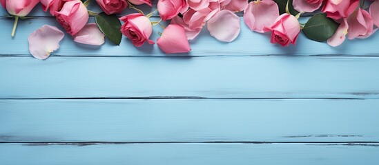 Poster - A copy space image featuring rose flowers and petals arranged on a blue wooden table background with beauty products