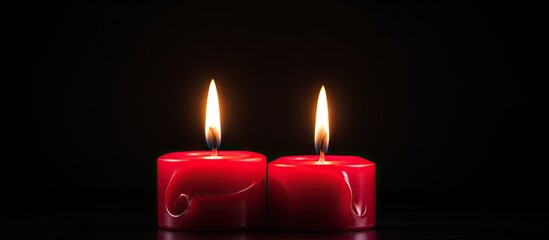Poster - A black background with two red candles burning providing a copy space image for text