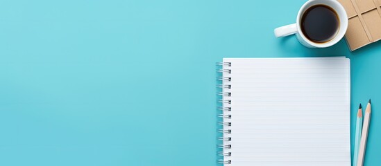 Fototapete - A monochrome school themed concept with a square notepad mockup and stationery on a blue background provides a minimal workspace with ample copy space image