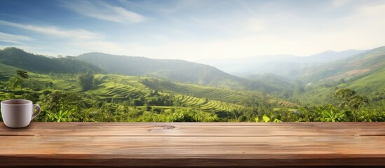 Poster - Copy space image of an empty wooden table overlooking a picturesque mountain or a wooden desk surrounded by a serene tea plantation with a blurred bokeh background Add your own text