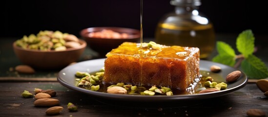 Poster - A close up image of the traditional Middle Eastern dessert Zalabya or Luqmat Al Kadi served with honey pistachio cinnamon sugar and oriental tea providing copy space