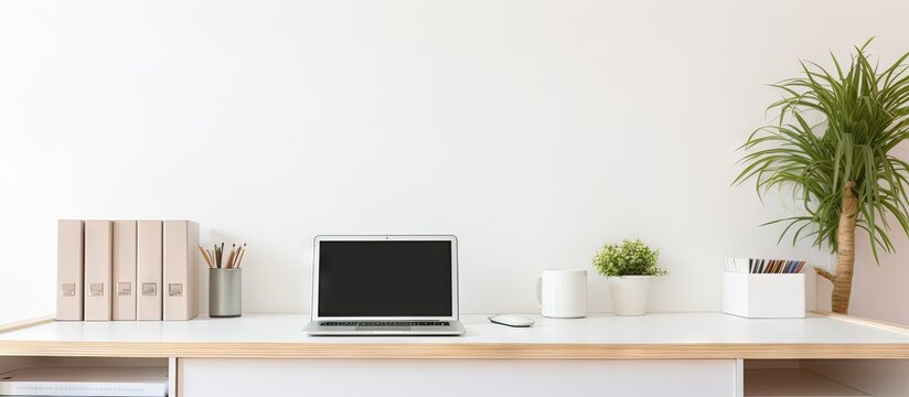 The home office features a modern white desk with a laptop stationery and a computer A copy space image is available for adding text or graphics