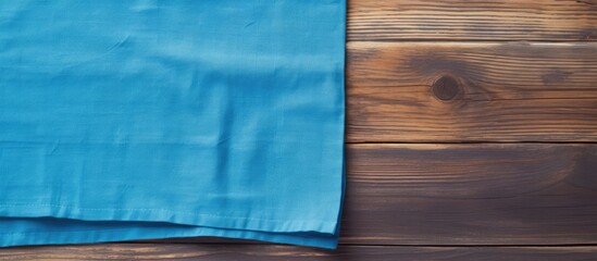 Poster - A kitchen cloth napkin is placed on a blue wooden background providing ample copy space for additional text or images