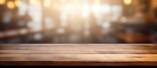 Poster - Clean and bright light foreground of a wood table with a blur coffee shop background This copy space image is perfect for displaying products through montage