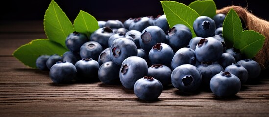 Poster - A copy space image of fresh blueberries is captured in a studio setting against a wooden background