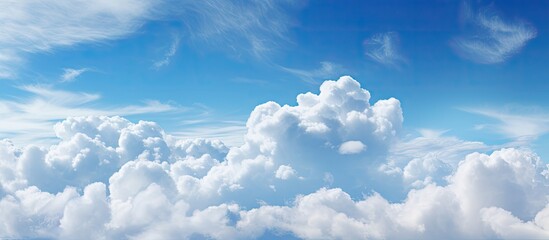 A cloudy sky with dreamy light soft white clouds and a blue sky offers a perfect copy space image This scenic background is ideal for product montages writing wallpapers and website banners It repres
