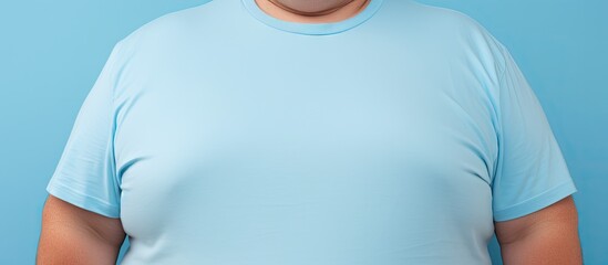 Aufkleber - Closeup of an overweight man wearing a tight shirt against a light blue background with copy space for text