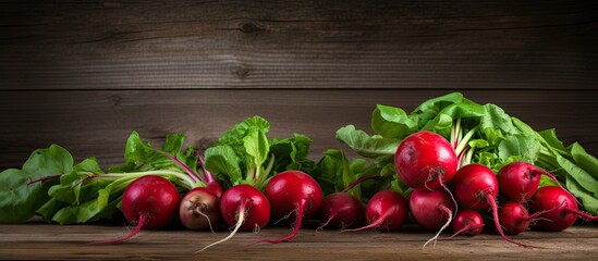Poster - An image of organic food vegetables specifically red radishes placed on a rustic wooden background with plenty of copy space