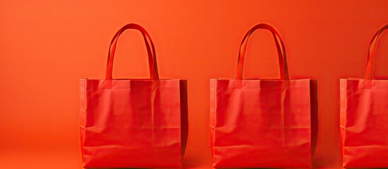 Poster - Colorful grocery shopping bags made of non woven polypropylene fabric featuring a vibrant red background These mockup bags provide ample space for text and logo placement
