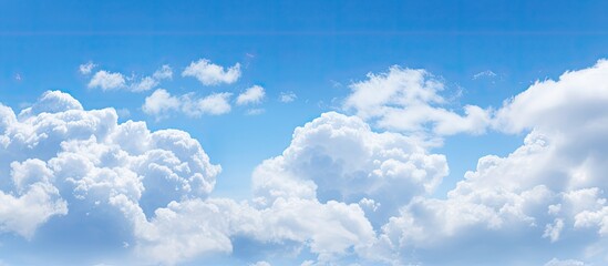 Poster - A copy space image depicts billowy white clouds against a tranquil blue sky