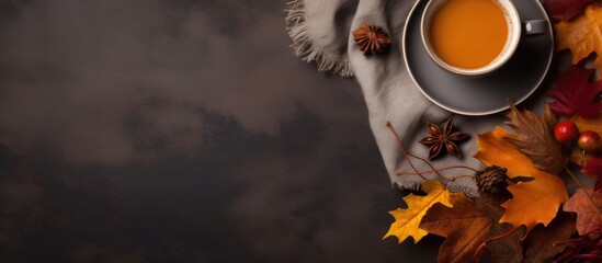 Aufkleber - A cozy autumn scene with a cup of hot coffee patchy blanket pumpkin shaped candles maple foliage and aromatic spices captured from above on a grey isolated background with copy space image