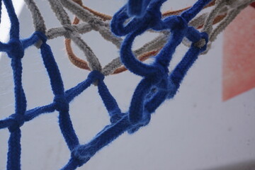 Macro of blue and white basketball hoop net