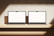 © Yevhen - Two Apple MacBooks Pro on the wooden desk on a plaster background