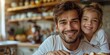© Iryna - In the kitchen, a smiling dad enjoys breakfast with his cheerful daughter, embodying positive parenting.