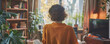 © Achirawee - In a minimalistic home office environment, a female employee is seen conversing on a video call with colleagues, her back to the camera. Soft, cozy colors evoke a sense of comfort and tranquility,
