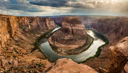 Wall Mural - A dramatic canyon landscape with a winding river at the bottom.
