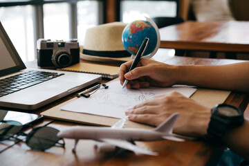 Young man writing his travel planning, Travel , Trip vacation, Tourism concept.