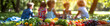© Carles - Vegetable and fruit foods focused with a family in the background in a natural park, summer concept vacation concept holidays