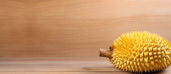 Aufkleber - Copy space image of a ripe durian fruit with thorns on a wooden board background perfect for adding text
