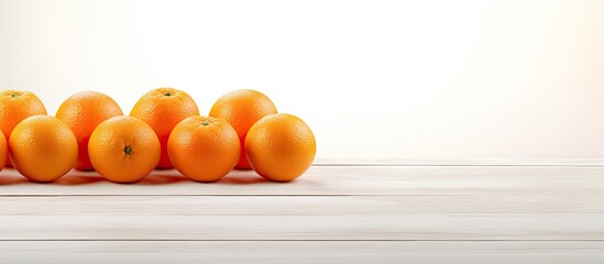 Poster - A copy space image of small tangerines resting on a clean white wooden table