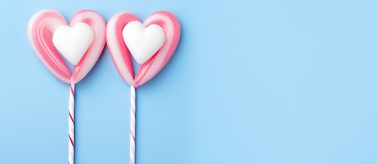 Aufkleber - High quality photo of white and blue heart shaped candy canes on a pink background with ample copy space
