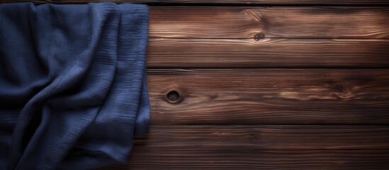 Canvas Print - The image showcases a towel laid on top of a dark wooden background leaving ample space for other elements