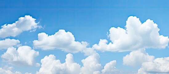 Poster - Copy space image featuring a serene blue sky adorned with fluffy white clouds