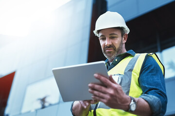 Poster - Tablet, engineer and man with helmet on construction site for development or building in city on project. Male person, tech and architecture as manager for progress in industrial, design and safety