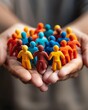 © Thanapipat - Diverse group of colorful figurines held in hands symbolizing community, unity, and teamwork. Bright representation of mutual support.