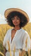 © Ananncee Media - A Black woman wearing a hat stands among tall grass in a field