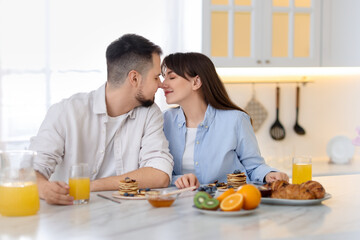 Canvas Print - Happy couple spending time together during breakfast at home