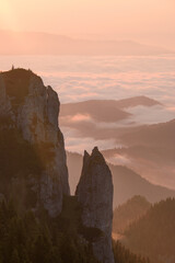 Wall Mural - Majestic cliffs against the background of hills and clouds at sunset