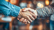 © Graphic Dude - Close up of two business people shaking hands in the office. Handshake concept.