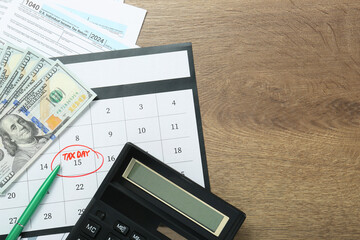 Wall Mural - Calendar with date reminder about tax day, documents, pen, money and calculator on wooden table, flat lay. Space for text