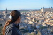 © Wirestock - a woman looking at a view of a city from the top