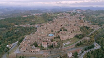 Wall Mural - Aerial footage of the cityscape of the village of Urbino at sunrise in Pesaro and Urbino, Italy