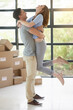© peopleimages.com - Couple, boxes and buy a new home, hug and property success or investment home loan. People, cardboard and embrace to rent apartment for achievement, relocation and purchase for real estate dream