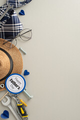 Wall Mural - Unique Father's Day presents for the handy dad. Vertical top view of tools, wrench, screws, nuts, straw hat, tie, glasses, postcard, hearts on light grey background, space for message