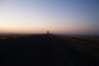 © Austockphoto - Country highway at sunrise with semi trailer truck driving off in distance